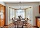 Charming breakfast nook with bay window and terracotta tile flooring at 7526 E Edgemont Ave, Scottsdale, AZ 85257