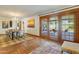 Well-lit dining space with a table for six, and doors leading to the outside patio at 7526 E Edgemont Ave, Scottsdale, AZ 85257