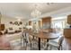 Bright dining area with a chandelier, a wooden table, and direct access to the living room at 7526 E Edgemont Ave, Scottsdale, AZ 85257