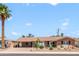 Charming single-story home featuring a covered carport, desert landscaping, and a mature palm tree at 7526 E Edgemont Ave, Scottsdale, AZ 85257