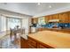 Spacious kitchen featuring wooden cabinets, blue backsplash, and breakfast nook with bay windows at 7526 E Edgemont Ave, Scottsdale, AZ 85257
