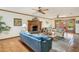 Spacious living room with brick fireplace, beamed ceilings, and doors to the outside at 7526 E Edgemont Ave, Scottsdale, AZ 85257