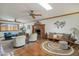 Inviting living room with brick fireplace, wooden mantel, and beamed ceilings at 7526 E Edgemont Ave, Scottsdale, AZ 85257