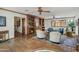 Spacious living room with built-in shelves, beamed ceilings, and tile floors at 7526 E Edgemont Ave, Scottsdale, AZ 85257