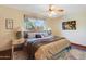 Bedroom with wood floors, soft colors, and a large window at 7526 E Edgemont Ave, Scottsdale, AZ 85257