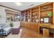 Cozy home office with built-in wooden shelving and large window at 7526 E Edgemont Ave, Scottsdale, AZ 85257