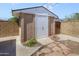 View of the storage shed with concrete block construction and a secure white door, providing ample space at 7526 E Edgemont Ave, Scottsdale, AZ 85257