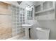 Clean bathroom featuring glass block shower and pedestal sink at 7530 E Mariposa Dr, Scottsdale, AZ 85251