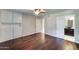 Spacious bedroom features hardwood floors, ceiling fan and adjacent bathroom at 7530 E Mariposa Dr, Scottsdale, AZ 85251