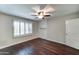 Bedroom with hardwood floors, shutters and a ceiling fan at 7530 E Mariposa Dr, Scottsdale, AZ 85251