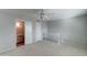 Bedroom with ceiling fan, carpet flooring, and open bathroom at 7530 E Mariposa Dr, Scottsdale, AZ 85251