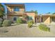 Charming two-story home features beautiful landscaping, a small balcony and a driveway at 7530 E Mariposa Dr, Scottsdale, AZ 85251
