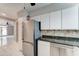 This home offers a modern kitchen with white cabinets and stainless steel appliances at 7530 E Mariposa Dr, Scottsdale, AZ 85251