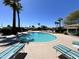 A sparkling blue community pool surrounded by lounge chairs and palm trees provides relaxation and fun at 7530 E Mariposa Dr, Scottsdale, AZ 85251