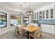 Bright dining room showcases a rustic wood table, designer light fixtures, and backyard views at 7816 S Lakeshore Dr, Tempe, AZ 85284