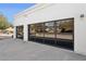 Modern glass garage doors providing natural light with large driveway at 7816 S Lakeshore Dr, Tempe, AZ 85284