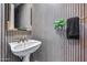 Elegant powder room featuring striped wallpaper, and classic fixtures at 8171 E Angel Spirit Dr, Scottsdale, AZ 85255