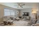 Living room with neutral paint, ceiling fan, large television, and view into the kitchen at 8305 E Lomita Ave, Mesa, AZ 85209