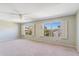 Bedroom featuring neutral carpet, two windows with shutters, and a ceiling fan at 9102 E Pershing Ave, Scottsdale, AZ 85260