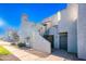 Charming stucco exterior with terracotta accents, staircase, and well-maintained landscaping, offering inviting curb appeal at 10115 E Mountain View Rd # 2112, Scottsdale, AZ 85258