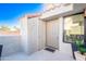 A welcoming front entrance with a neutral-colored door, adjacent storage, and stylish planters adding a touch of greenery at 10115 E Mountain View Rd # 2112, Scottsdale, AZ 85258