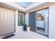 A cozy patio entrance with a sliding glass door, potted plants, and neutral tones, creating a peaceful transition inside at 10115 E Mountain View Rd # 2112, Scottsdale, AZ 85258