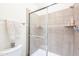 Updated tiled shower with glass doors and a built-in shelf at 10115 E Mountain View Rd # 2112, Scottsdale, AZ 85258