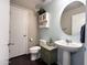 Stylish half-bath with pedestal sink, decorative accents, and tiled floors at 1042 S Cheshire Ln, Gilbert, AZ 85296