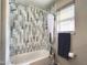 Stylish bathroom features tiled walls and a shower over the tub at 1042 S Cheshire Ln, Gilbert, AZ 85296