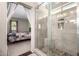 Bathroom showcasing a glass shower, tile surround, and view into the bedroom at 1042 S Cheshire Ln, Gilbert, AZ 85296