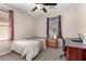 Cozy bedroom with natural light, a ceiling fan, and a functional desk area at 1042 S Cheshire Ln, Gilbert, AZ 85296