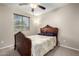 Bedroom showcasing a decorative bed frame, ceiling fan, and plush carpet at 1042 S Cheshire Ln, Gilbert, AZ 85296