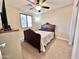 Cozy bedroom with a ceiling fan and a classic wooden bed frame at 1042 S Cheshire Ln, Gilbert, AZ 85296