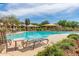 A relaxing community pool with chaise lounges provides an idyllic setting and relaxing atmosphere at 1042 S Cheshire Ln, Gilbert, AZ 85296