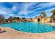 A sparkling community pool with ample lounge seating is surrounded by inviting clear blue skies at 1042 S Cheshire Ln, Gilbert, AZ 85296