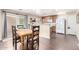 Cozy dining area open to kitchen, featuring hardwood floors and access to outdoor space at 1042 S Cheshire Ln, Gilbert, AZ 85296