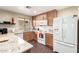 Well-lit kitchen with white appliances, ample cabinet space, and granite countertops at 1042 S Cheshire Ln, Gilbert, AZ 85296