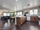 Open kitchen featuring wood cabinets, granite countertops, and view to the living room at 1042 S Cheshire Ln, Gilbert, AZ 85296