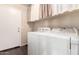 Laundry room with a washer, dryer, and a door leading to the outside at 1042 S Cheshire Ln, Gilbert, AZ 85296