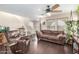 Bright living room with hardwood floors, ceiling fan, and comfortable seating area at 1042 S Cheshire Ln, Gilbert, AZ 85296