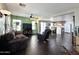 Inviting living room with dark wood floors, ceiling fan, and open access to the kitchen at 1042 S Cheshire Ln, Gilbert, AZ 85296