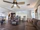 Comfortable living room with dark wood floors, ceiling fan, staircase, and cozy furniture at 1042 S Cheshire Ln, Gilbert, AZ 85296