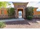 A stone archway provides access to the community pool, enhanced by lush greenery and gated entry at 1042 S Cheshire Ln, Gilbert, AZ 85296