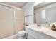 Bright bathroom featuring a frosted glass shower door, and a spacious vanity with a white countertop at 10891 W Clair Dr, Sun City, AZ 85351