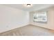 Bright bedroom with neutral carpet and window at 10891 W Clair Dr, Sun City, AZ 85351