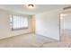 Bright bedroom with neutral carpet and window at 10891 W Clair Dr, Sun City, AZ 85351