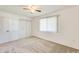 Carpeted bedroom featuring a ceiling fan, window with blinds, and closet with double doors at 10891 W Clair Dr, Sun City, AZ 85351