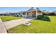 Attractive home featuring well-manicured lawn, a covered carport, and desert landscaping at 10891 W Clair Dr, Sun City, AZ 85351