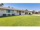 Charming home featuring well-manicured lawn, mature landscaping, and a covered carport at 10891 W Clair Dr, Sun City, AZ 85351