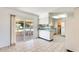 Bright kitchen with tile floors and sliding glass doors to the outdoor patio area at 10891 W Clair Dr, Sun City, AZ 85351